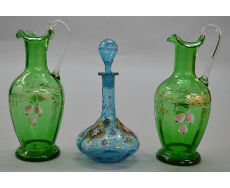 A pair of Victorian hand-painted glass water jugs together with a similar decanter with original stopper (3)