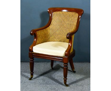 A William IV Mahogany Berg&egrave;re Chair,&nbsp;with curved crest rail, cane panelled seat and back, on turned and reeded fr