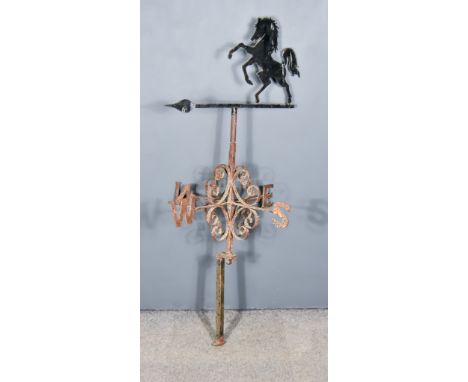 A Cast Iron Weather Vane, surmounted by a rearing horse and with c-scroll brackets, 55ins high