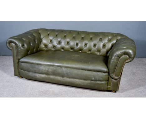 A Late 19th/Early 20th Century Drop End Two Seat Chesterfield Settee, the out scrolled arms and back buttoned, the whole upho