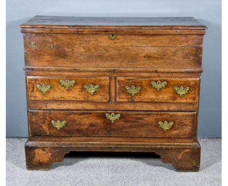 An 18th Century Oak Mule Chest with Moulded Cornice to Lifting Top, fitted two short and one long drawer under, on bracket fe