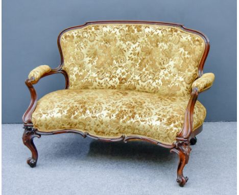 A 19th Century French Walnut Framed Two Seat Settee of 'Louis XV' design, with shaped and moulded showwood frame and moulded 