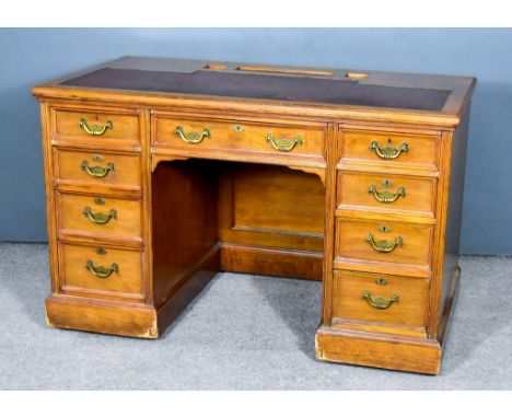 A Victorian Walnut Kneehole Desk, by Maple &amp; Co., the top with inkwell and pen compartments, and red cloth inset, and wit
