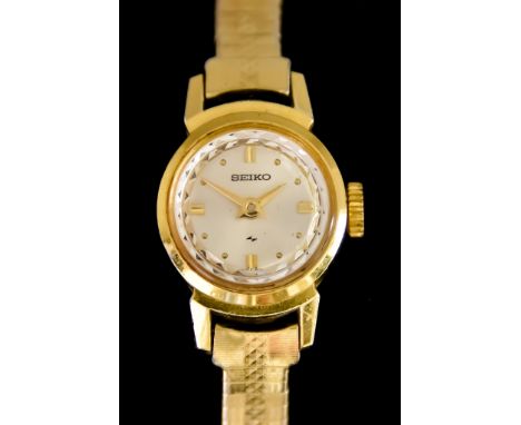 A Lady's Manual Wind Wristwatch, by Seiko, 9ct gold case, 16mm diameter, silver dial with gold baton numerals, on non-conform
