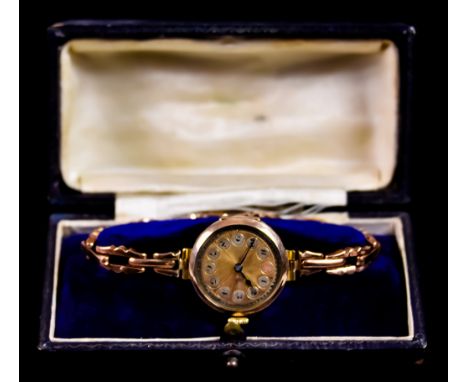 A Lady's Manual Wind Wristwatch,&nbsp;9ct gold case, 25mm diameter, gold radial dial with Arabic baton numerals, 9ct gold exp