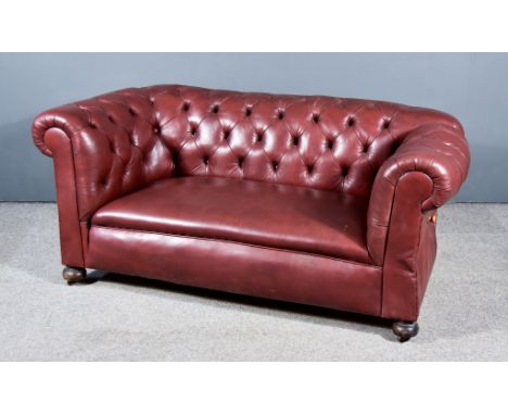 A Late 19th/Early 20th Century Drop End Two Seat Chesterfield Settee, the out scrolled arms and backs buttoned, the whole uph