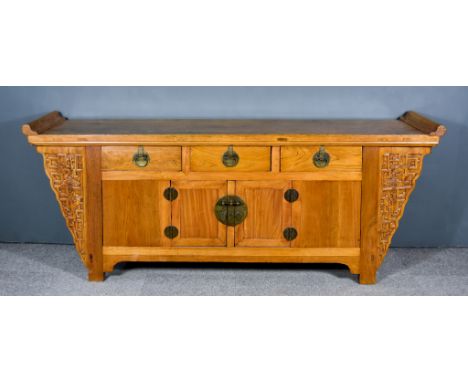 A Chinese Elm Altar Top Side Cabinet, the flush panel top with scroll moulded ends, fitted three frieze drawers, cupboard und