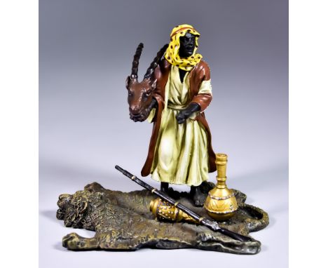 After Franz Bergman (1838-1894) - Cold painted bronze - Figure of a Bedouin Trader, holding Ibex head on tiger skin rug, amph