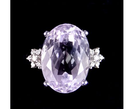 A 9ct White Gold Kunzite and Diamond Ring, set with a centre faceted Kunzite, approximately 8.2ct, flanked by two brilliant c