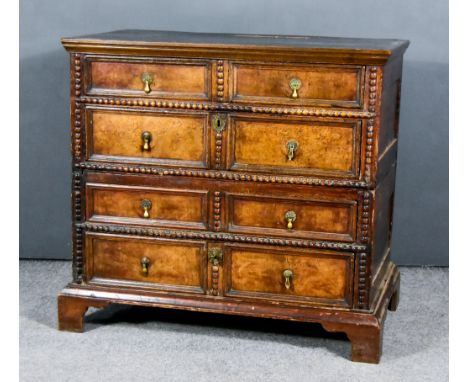 A 17th Century Panelled Oak Walnut and Pine Chest in Two Sections, with moulded edge to top, fitted four long drawers with tw