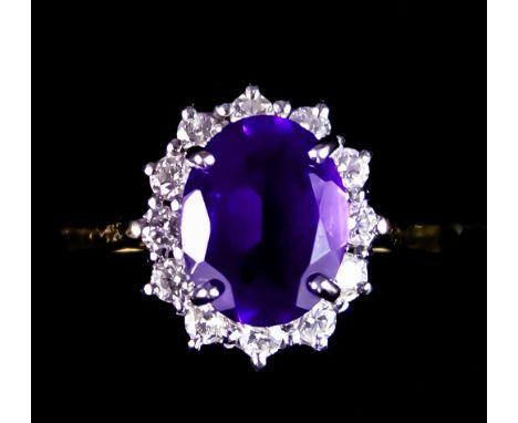 An 18ct Gold Amethyst and Diamond Ring, set with a centre amethyst, approximately 2ct, surrounded by small brilliant cut whit
