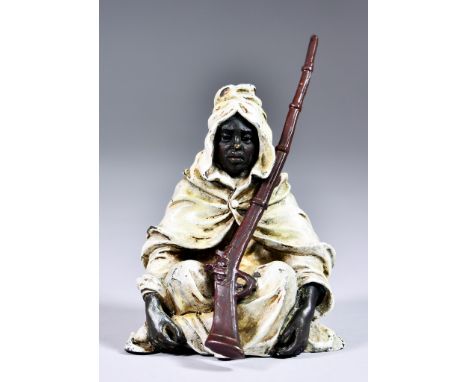 After Franz Bergman (1838-1894) - Cold painted bronze - Seated figure of a Bedouin holding a rifle, stamped with urn mark and