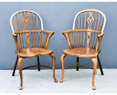 A Pair of Ash and Elm Windsor Armchairs, each with curved crest rails, vase pattern splats, dish wood seats, on horseshoe str