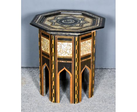 An Early 20th Century Moorish Mother-of-Pearl Inlaid and Ebonised Wood Octagonal Occasional Table, on arched plank legs, 18.5