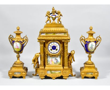A 19th Century French Gilt Metal Clock Garniture, the clock by A D Mougin, the 3.5ins diameter porcelain dial with Arabic num