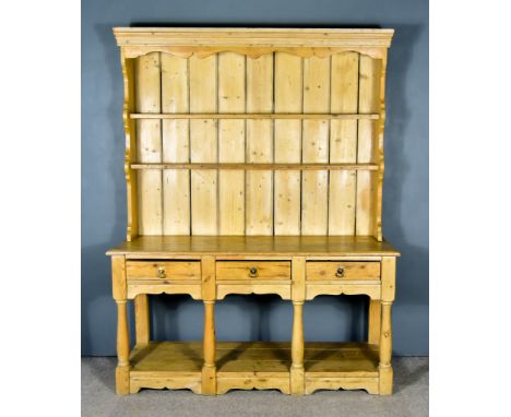 A Pine Dresser of 18th Century Design, the upper part with moulded cornice and shaped frieze, fitted two open shelves, the ba