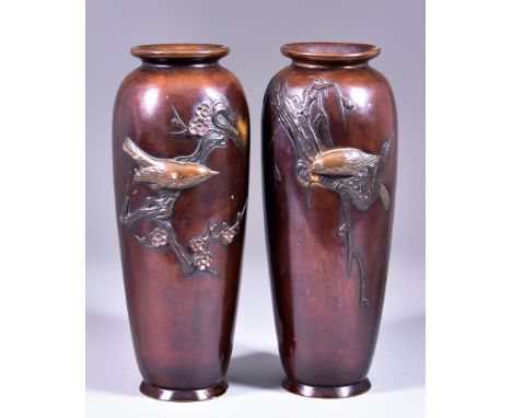 A Pair of Japanese Brown Patinated Bronze Vases, Meiji Period, moulded in relief with birds perched on branches, one with blo