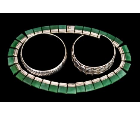 A Mexican Silver and Jadite Necklace and Two White Metal Stiff Bangles, the necklace, stamped 925, of fringe pattern, one ban