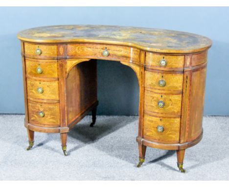 An Edwardian Mahogany and Inlaid Kidney Shaped Kneehole Desk, with brown leather and tooled inset, cross-banding and floral m