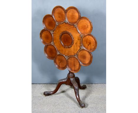 A George III Mahogany Tripod Supper Table, with eleven moulded circular insets to top, on leaf carved baluster turned central