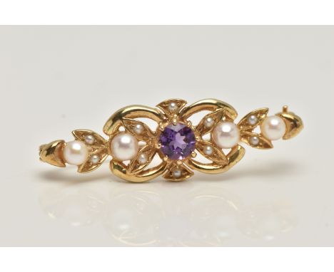 A 9CT GOLD AMETHYST AND SEED PEARL BROOCH, open work brooch set with a central circular cut amethyst, with seed pearl accents