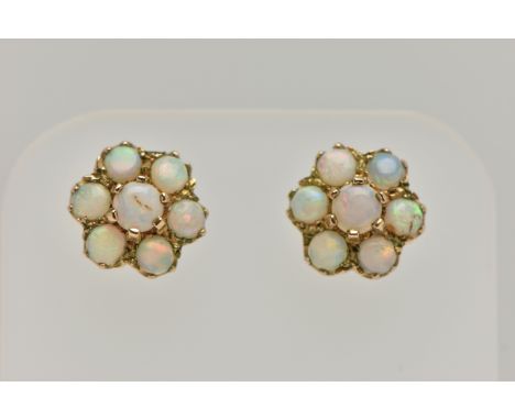 A PAIR OF GOLD OPAL CLUSTER EAR STUDS, designed as seven circular opal cabochons claw set in a cluster, with hallmark which i