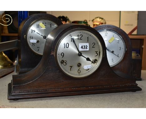 THREE OAK CASED MANTEL CLOCKS, eight day striking, one clock has maker's mark Smiths Enfield, two keys and a pendulum, height