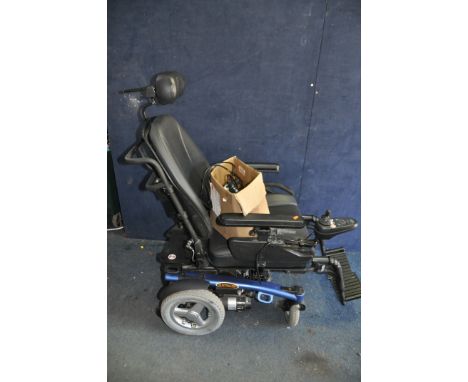 A PRIDE MOBILITY ARTEMIS ELECTRIC WHEELCHAIR with headrest, two footrests, charger and manual (PAT pass and working) (Conditi