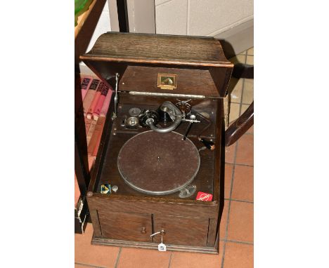 AN EARLY 20TH CENTURY OAK CASED HMV MODEL 109 TABLE TOP GRAMOPHONE, with winding handle, an HMV needle tin containing a small