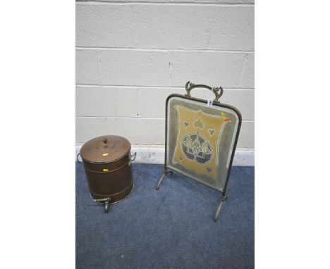 AN ARTS AND CRAFTS BRASS FIRESCREEN with a coloured glass panel, 42cm x 72cm, and a copper water urn (condition report: good)