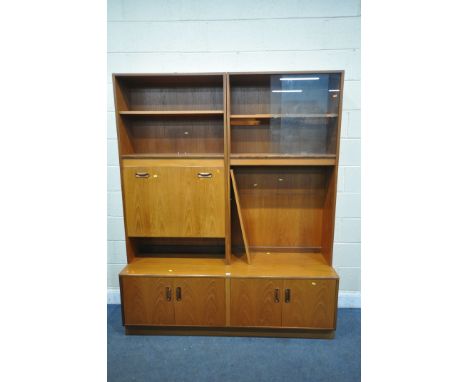 A MID-CENTURY G PLAN FRESCO WALL CABINET, with an arrangement of shelving, glazed doors, fall front cocktail section, above t