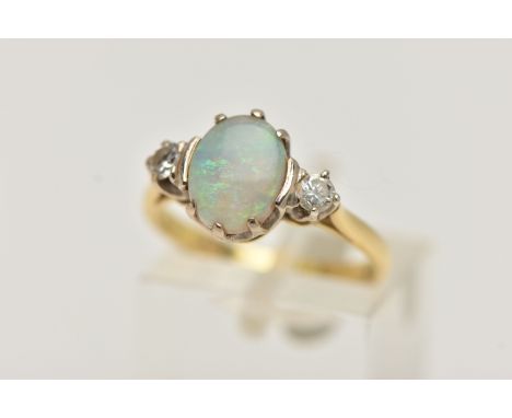 AN 18CT GOLD OPAL AND DIAMOND RING, designed as a central oval opal flanked by brilliant cut diamonds, estimated total diamon