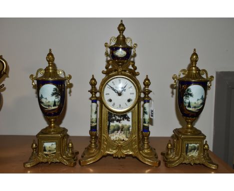 A MODERN ITALIAN 'IMPERIAL' BRASS AND PORCELAIN CLOCK GARNITURE, the finials, columns and front all transfer printed with sce