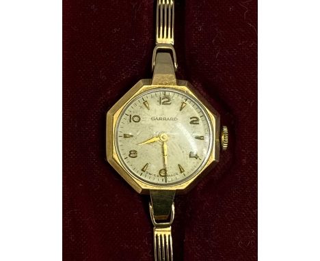 GARRARD &amp; CO LADY'S 9CT GOLD BRACELET WRISTWATCH - in original box with paperwork, the dial set with Arabic even numbers 