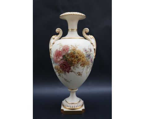 A large Royal Worcester twin handled vase with a flared rim and scrolling handles, the body decorated with flowers and leaves