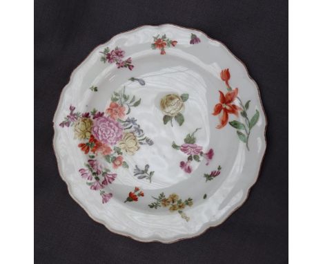 A porcelain plate with a shaped edge, painted with sprays of garden flowers, 'Chelsea' red anchor mark to the base, 21.5cm di