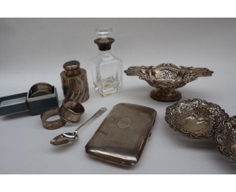 A late Victorian silver cigar case, of rectangular form with line decoration and a roundel depicting an otter pierced by an a