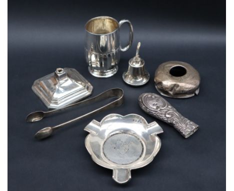 An Edward VII silver christening mug with a lobed body on a pedestal foot, Sheffield, 1905, Henry Atkin together with a silve