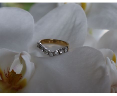 A diamond ring of V shaped set with eight round brilliant cut diamonds, to a white metal setting and 18ct yellow gold shank, 