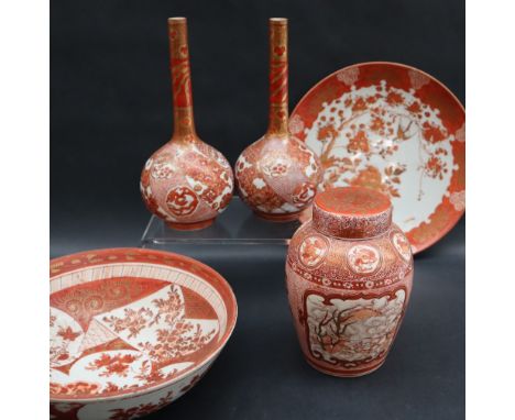 A pair of Japanese Kutani porcelain bottle vases decorated with dragons, flower heads and scales, signed to the base, 18cm hi