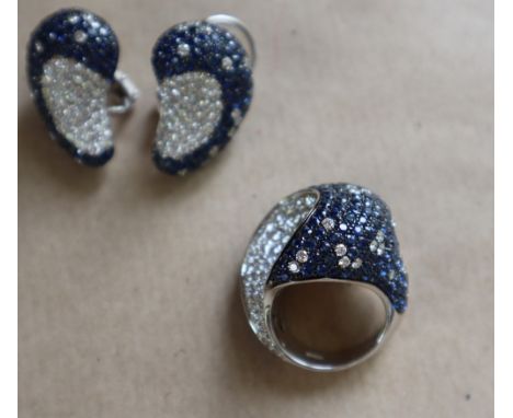 An 18ct white gold Valente diamond and sapphire encrusted ring set with round brilliant cut diamonds and round faceted sapphi