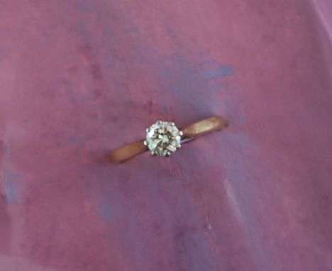 A solitaire diamond ring, the round old cut diamond approximately 0.5cts to a white metal setting and 18ct yellow gold shank,