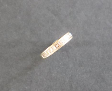 An 18ct white gold half eternity ring set with princess and baguette cut diamonds to an 18ct white gold setting and shank, si