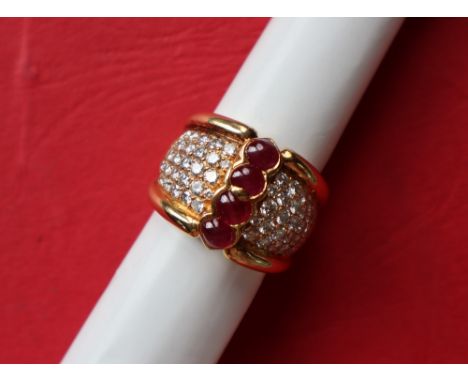 An 18ct gold ruby and diamond ring, set with four heart shaped cabochon rubies and five lines of round brilliant cut diamonds