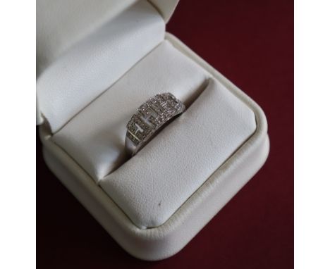 A 9ct white gold diamond ring set with round brilliant cut diamonds in a geometric pattern, size R, approximately 3 grams