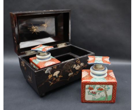 A Victorian Papier Mache tea caddy inlaid with mother of pearl depicting birds, leaves, flowers and bamboo containing a pair 