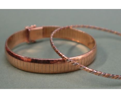 An 18ct yellow gold sectional bracelet, 19cm long, together with an 18ct two tone gold bangle, approximately 46.5 grams