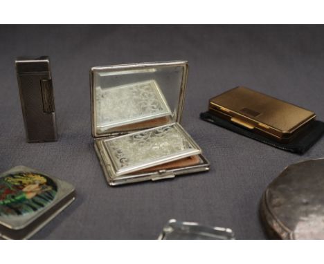 A Sterling silver powder compact with engine turned decoration, together with other powder compacts, a silver vesta case, a s