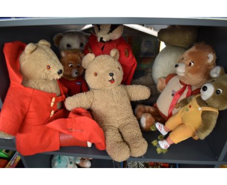 A shelf of 1980's and later teddy bears including Teddy Ruxpin, Teleconcepta, Paddington, Badger etc (8)