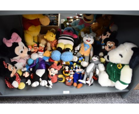 A shelf of Mickey Mouse, Winnie the Pooh, Snoopy and similar soft toys and collectables